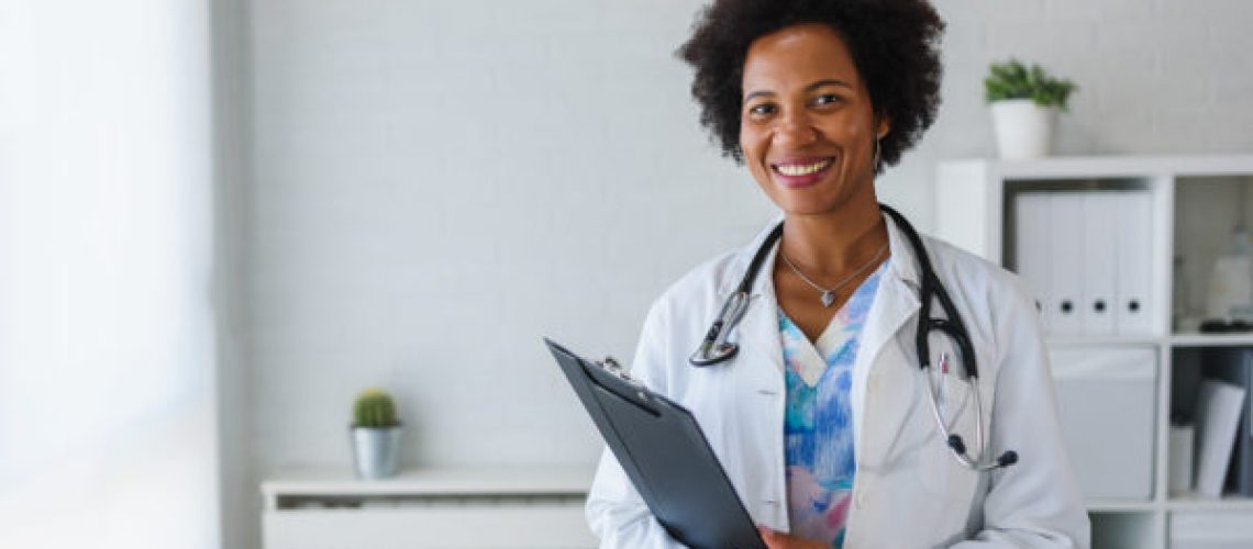 Portrait of female African American doctor standing in her offic