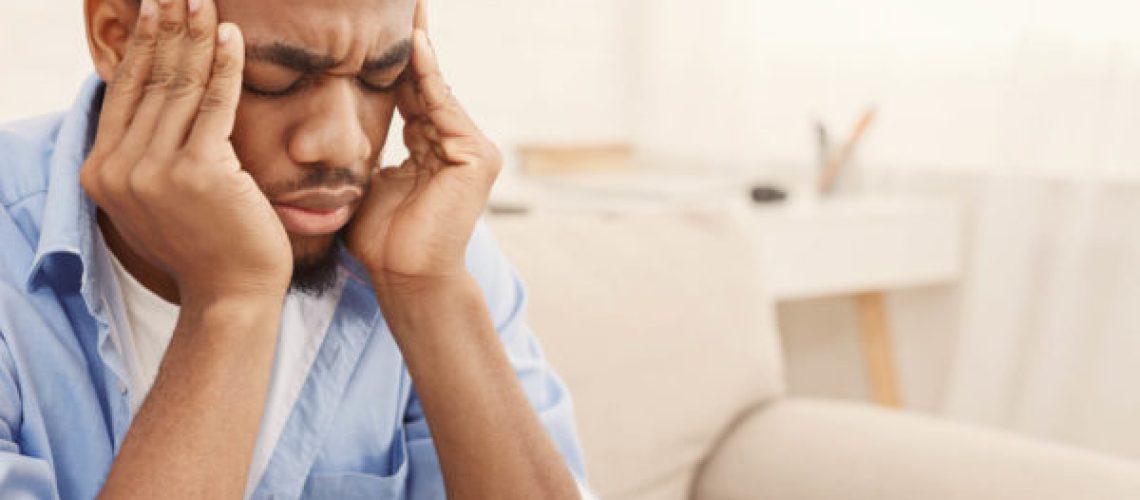 Exhausting migraine. Young african-american man suffering from headache at home, copy space