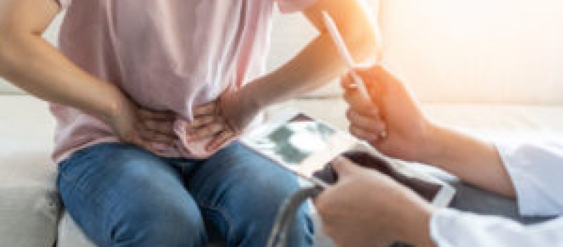 Abdominal pain patient woman having medical exam with doctor on illness from stomach cancer, irritable bowel syndrome, pelvic discomfort, Indigestion, Diarrhea, GERD (gastro-esophageal reflux disease)
